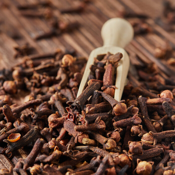 Dried spice herbs cloves for flavoring foods and natural medicines, Indian spice ingredient on wooden background.